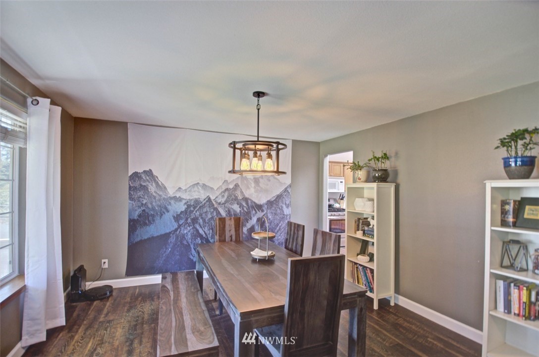 21741 Michigan Hill Road Southwest Rochester, WA 98579 - Photo 6 of 27 a view of a dining room with furniture window and wooden floor