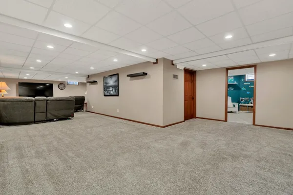 a bedroom with furniture and a flat screen tv