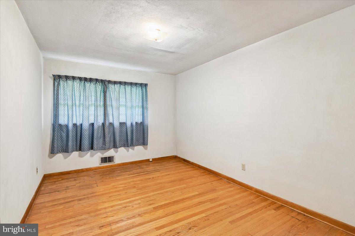 1509 Duvall Road Annapolis, MD 21409 - Photo 31 of 39 an empty room with wooden floor and windows