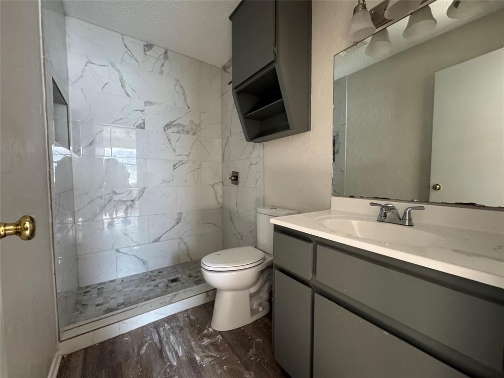 1421 South 12th Street, Unit 107 Waco, TX 76706 - Photo 11 of 25 a bathroom with a sink toilet a mirror and shower