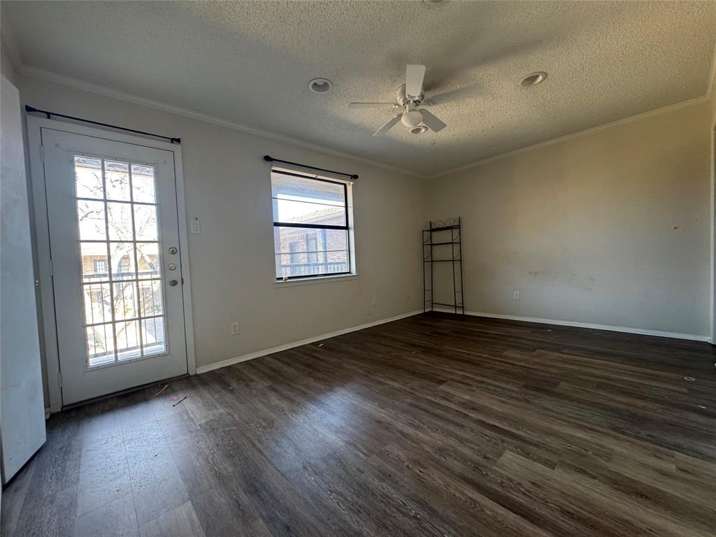 1421 South 12th Street, Unit 107 Waco, TX 76706 - Photo 16 of 25 a view of an empty room with wooden floor and a window
