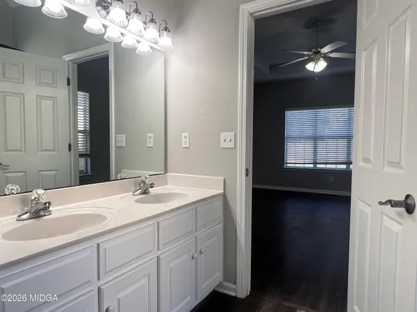 a bathroom with a sink vanity and a mirror