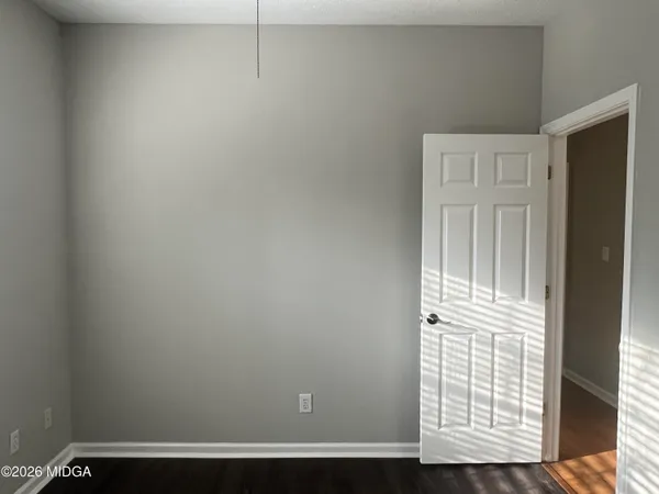 a view of wooden floor and windows in a room