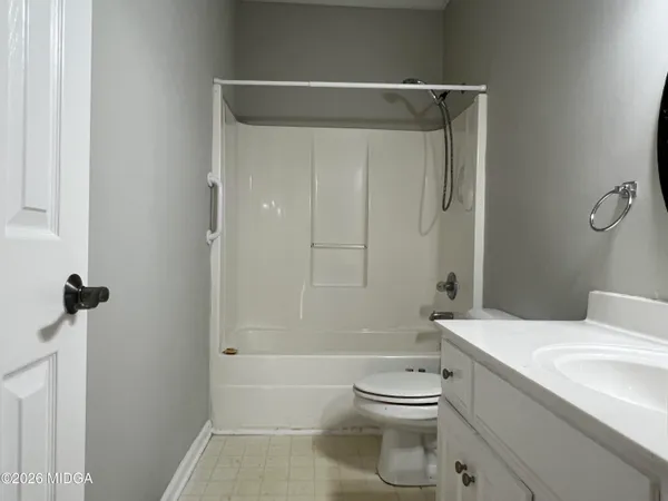 a bathroom with a toilet a sink and shower