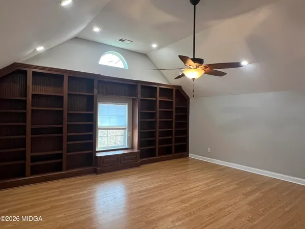 a view of an empty room with a fireplace and a window