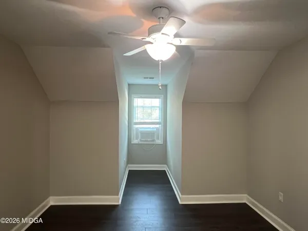 wooden floor in an empty room with a mirror