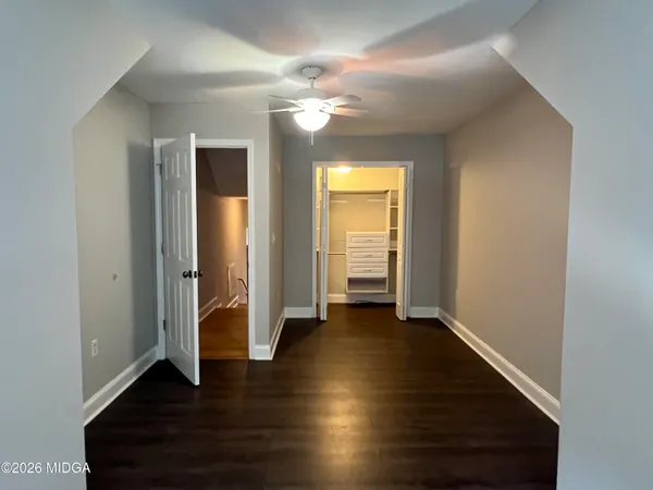 an empty room with wooden floor and closet