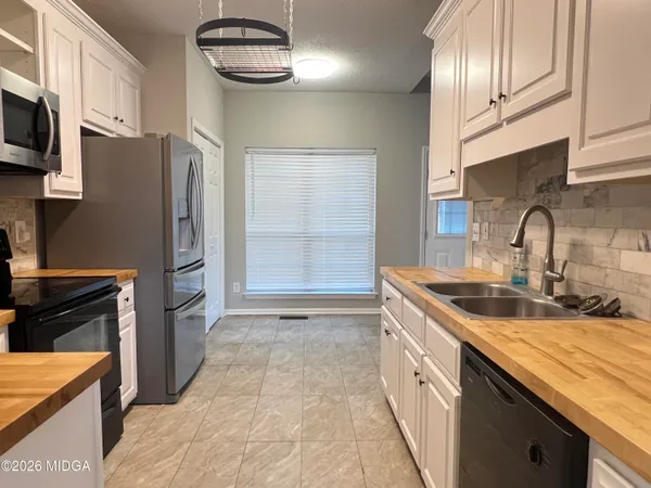 a kitchen with stainless steel appliances granite countertop a sink and a stove
