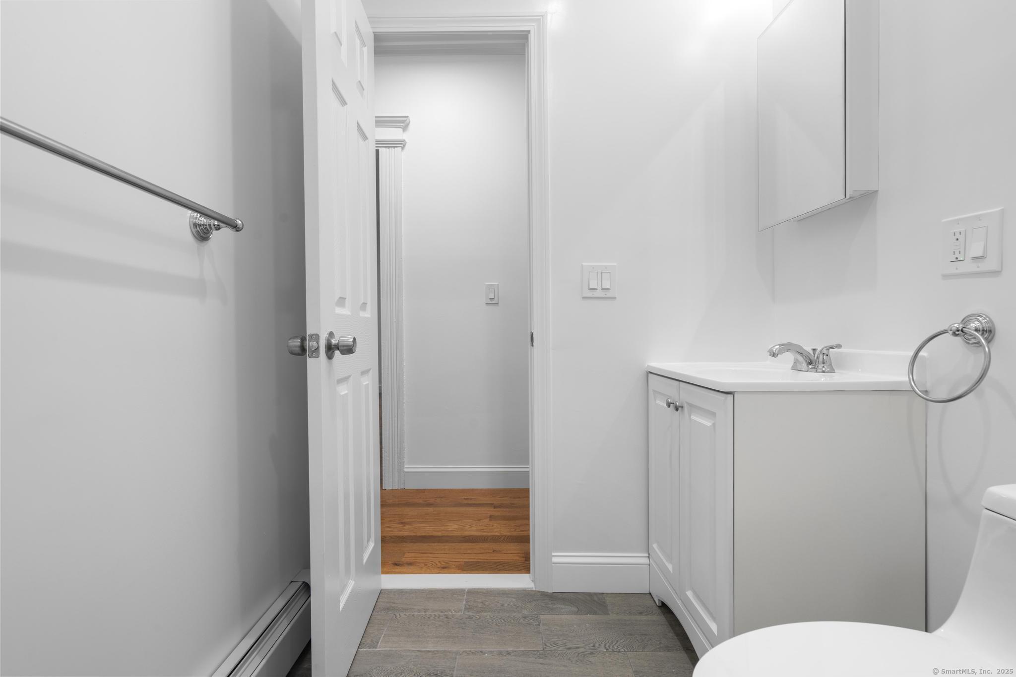 565 Carroll Avenue, Unit 1 Bridgeport, CT 06607 - Photo 12 of 22 a bathroom with a sink and shower