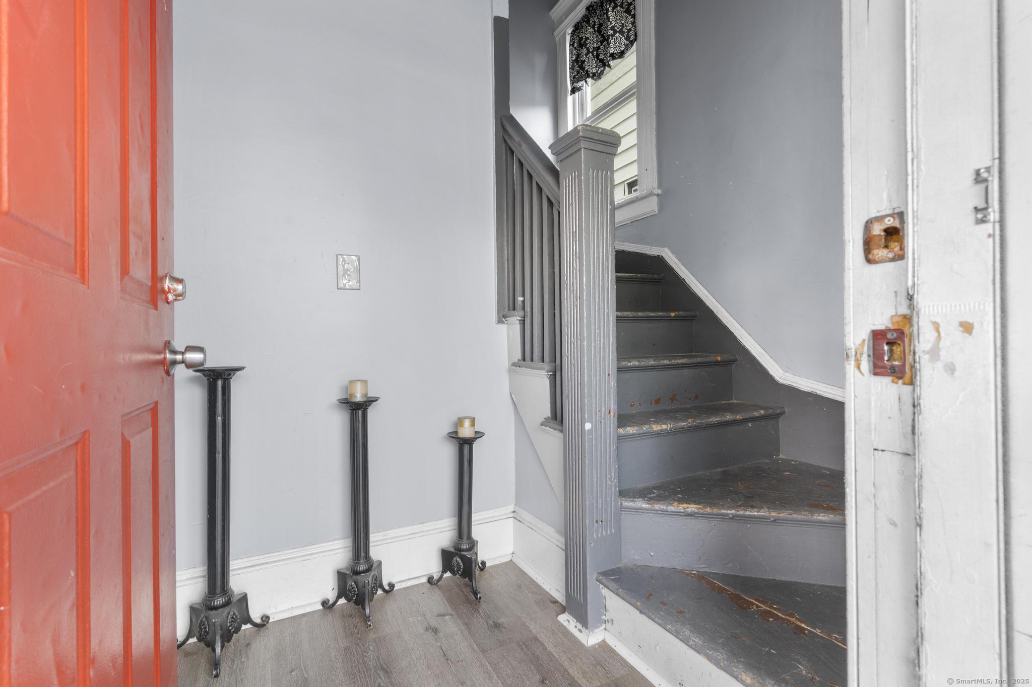 565 Carroll Avenue, Unit 1 Bridgeport, CT 06607 - Photo 2 of 22 a view of a hallway with wooden floor and staircase