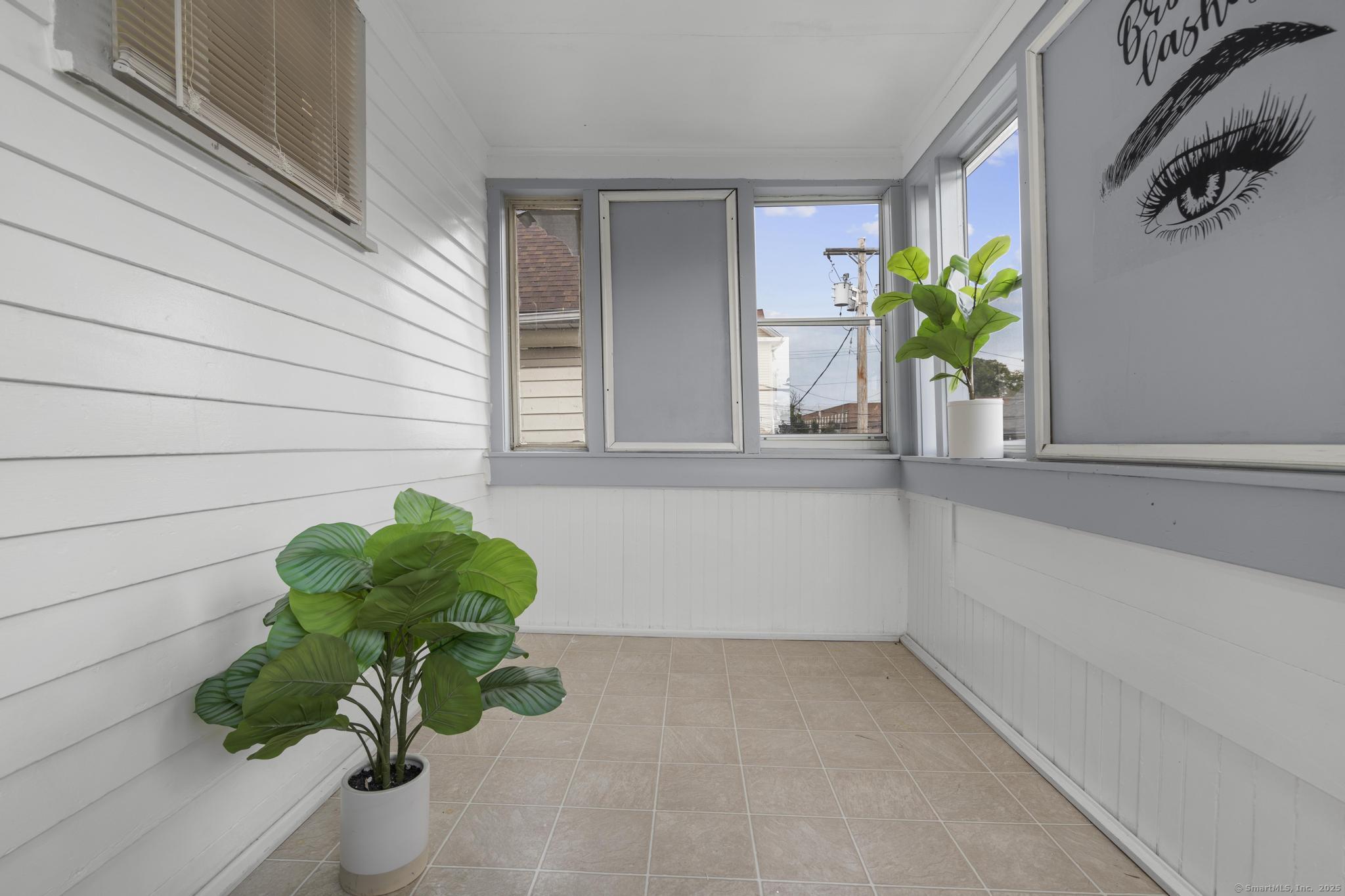 565 Carroll Avenue, Unit 1 Bridgeport, CT 06607 - Photo 4 of 22 a white vase with white and yellow flowers