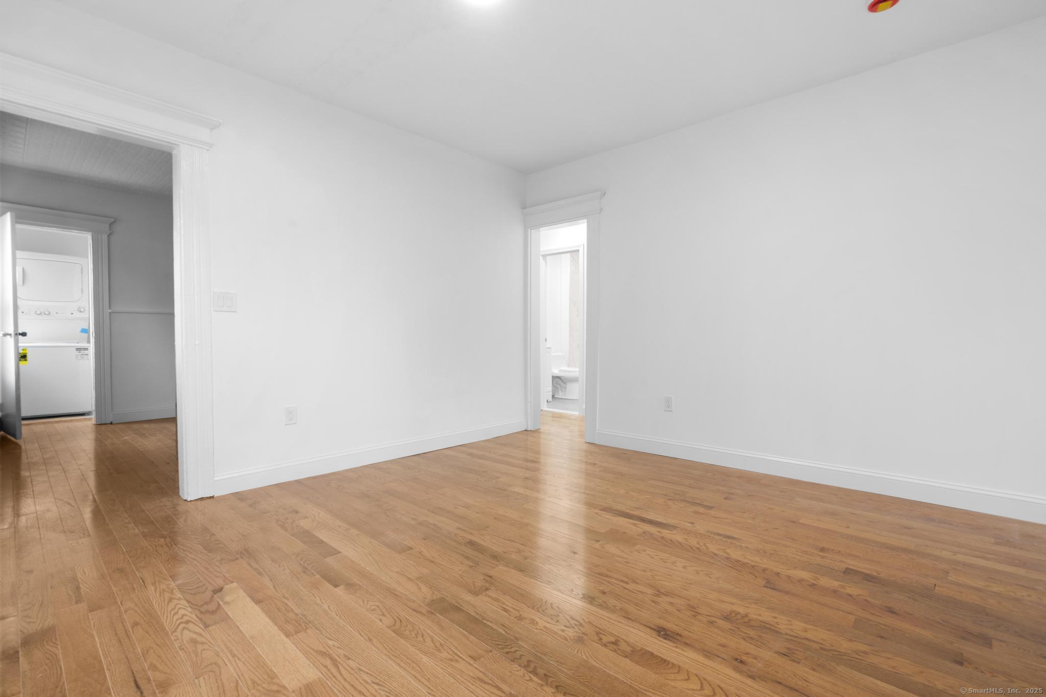 565 Carroll Avenue, Unit 1 Bridgeport, CT 06607 - Photo 6 of 22 a view of an empty room and wooden floor