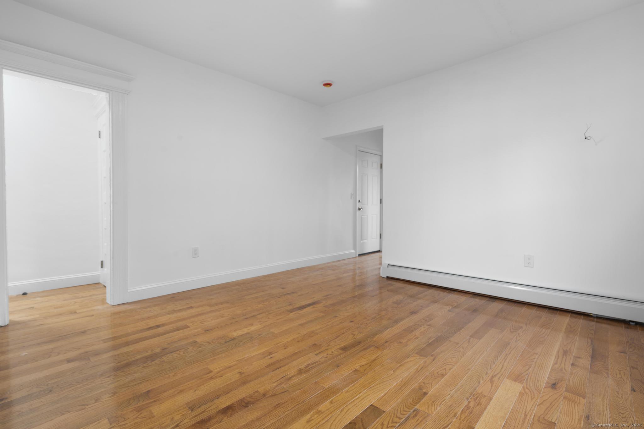565 Carroll Avenue, Unit 1 Bridgeport, CT 06607 - Photo 8 of 22 a view of an empty room and wooden floor