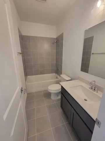 a bathroom with a double vanity sink toilet and shower
