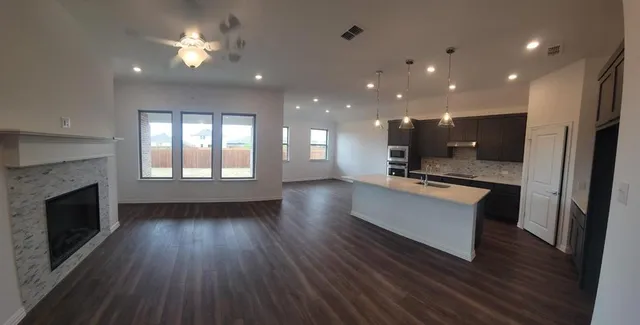 a view of kitchen with sink microwave and refrigerator
