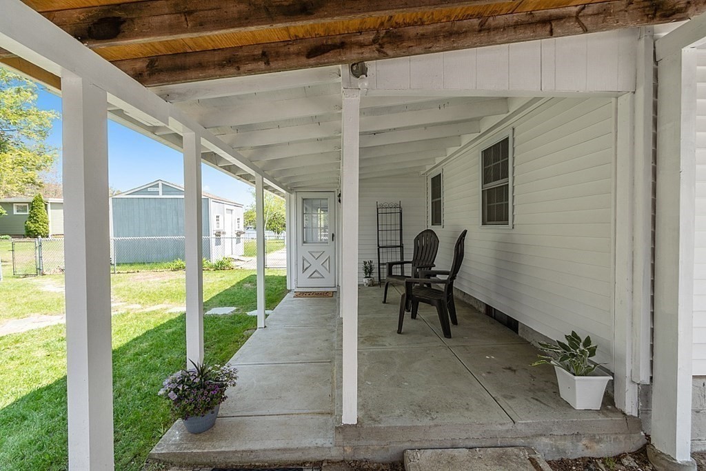 20 Fern Lane Manchester, NH 03109 - Photo 28 of 34 a view of a porch with chairs and backyard
