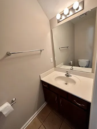 a bathroom with a sink vanity and mirror