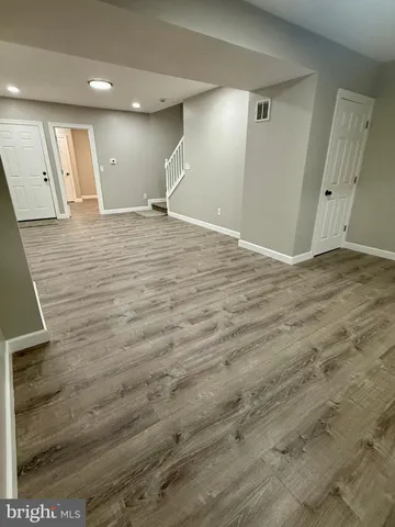 an empty room with wooden floor