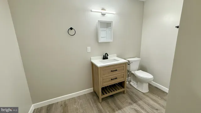 a bathroom with a toilet a sink and mirror