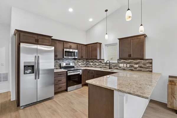 a kitchen with a sink stainless steel appliances and counter space