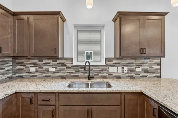 a kitchen with stainless steel appliances granite countertop a sink a stove and cabinets