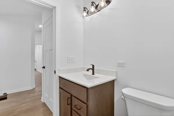 a bathroom with a sink toilet and vanity