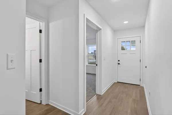 a view of a hallway with wooden floor