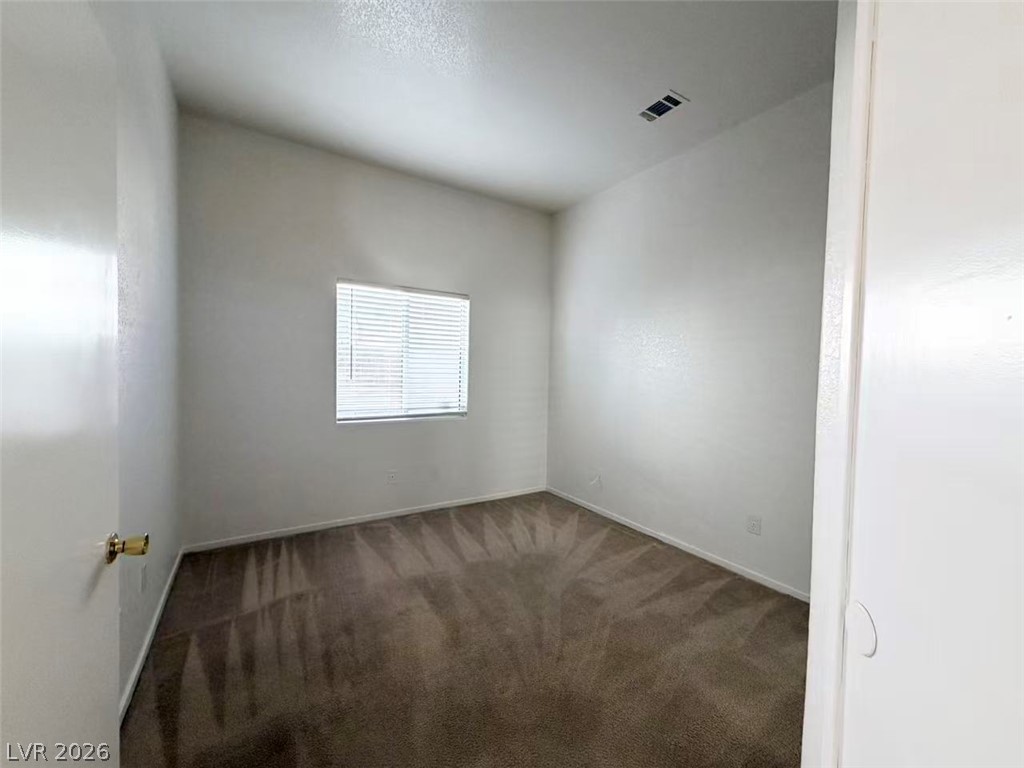 8620 Magnolia Ridge Avenue Las Vegas, NV 89134 - Photo 10 of 15 A well-proportioned bedroom awaits personalization with its inviting carpet and single window.
