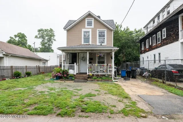 a front view of a house with sitting area and garden