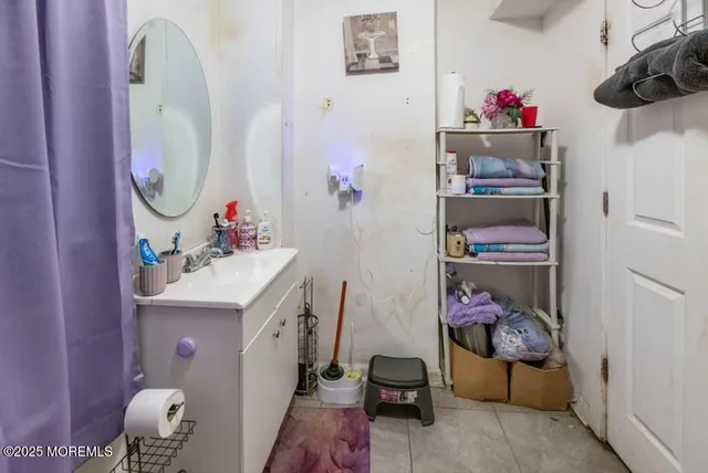 a bathroom with a sink mirror and vanity