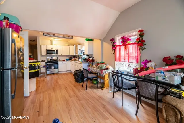 a dining room with furniture window and wooden floor