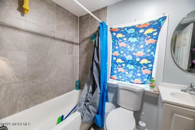 a white toilet sitting next to a bath tub