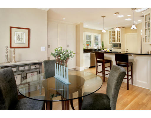121 University Road, Unit 1 Brookline, MA 02445 - Photo 3 of 13 a dining room with furniture and wooden floor