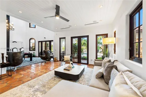 a living room with furniture large window and flat screen tv