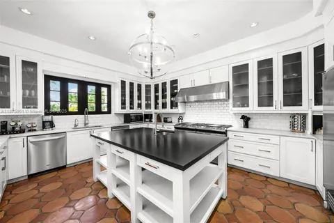 a kitchen with a stove sink and cabinets