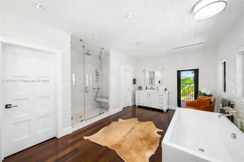 a large spacious bathroom with a tub and shower