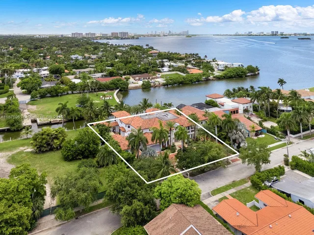 an aerial view of water body with boats and trees all around