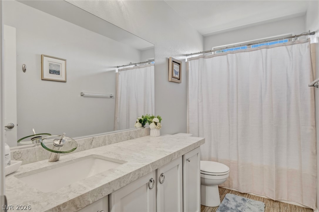 48 Jasmine Point Street Henderson, NV 89074 - Photo 49 of 62 A sleek vanity with ample counter space anchors this modern bath.