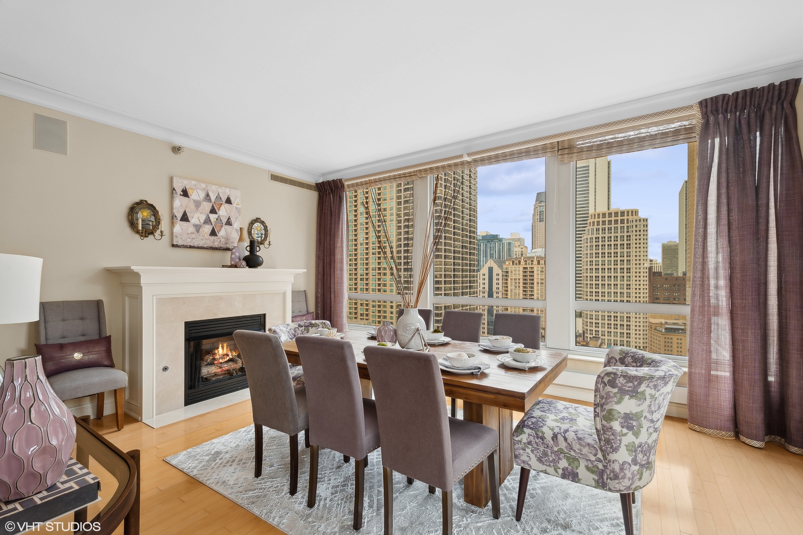 55 East Erie Street, Unit 2103 Chicago, IL 60611 - Photo 7 of 24 a dining room with furniture a fireplace and wooden floor