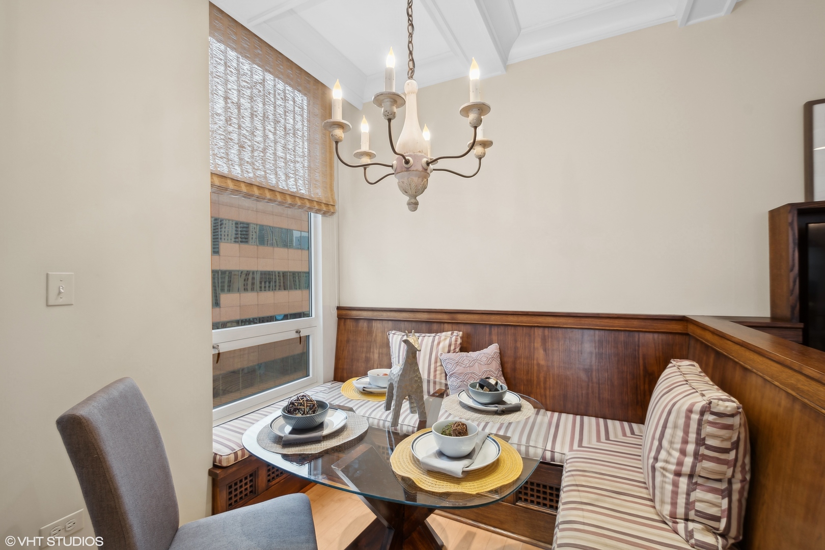55 East Erie Street, Unit 2103 Chicago, IL 60611 - Photo 10 of 24 a view of a dining room with furniture a chandelier and wooden floor