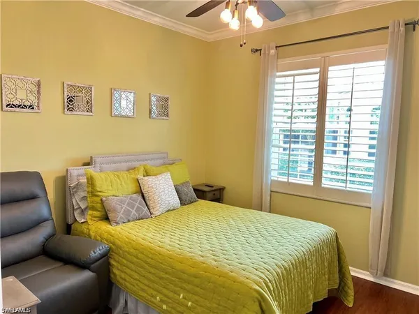 a bed sitting in a bedroom next to a window