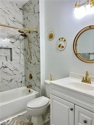 a bathroom with a sink mirror vanity and toilet