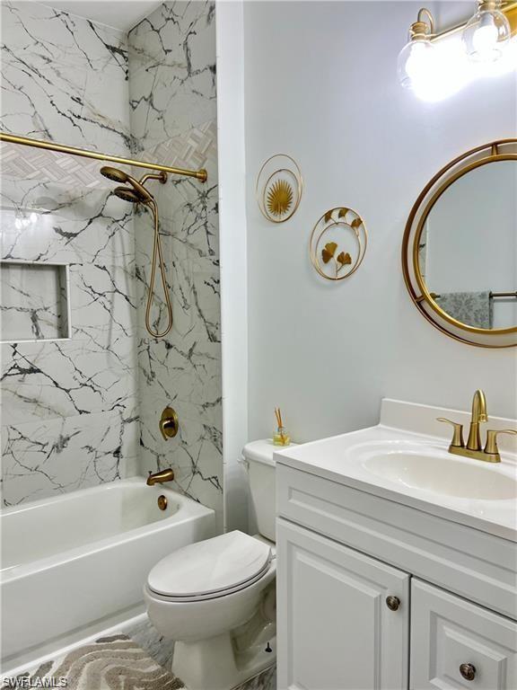 1812 Avian Court, Unit A78 Naples, FL 34119 - Photo 14 of 19 a bathroom with a sink mirror vanity and toilet