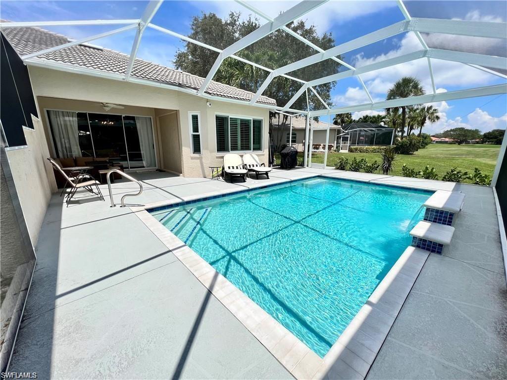 1812 Avian Court, Unit A78 Naples, FL 34119 - Photo 16 of 19 a view of a patio with table and chairs with wooden floor and barbeque oven
