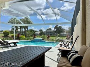 1812 Avian Court, Unit A78 Naples, FL 34119 - Photo 18 of 19 a view of a patio with table and chairs potted plants with wooden floor