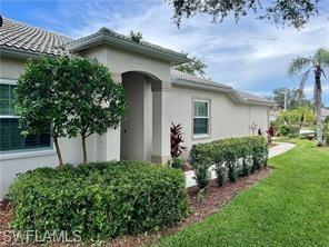 1812 Avian Court, Unit A78 Naples, FL 34119 - Photo 19 of 19 a front view of a house with garden