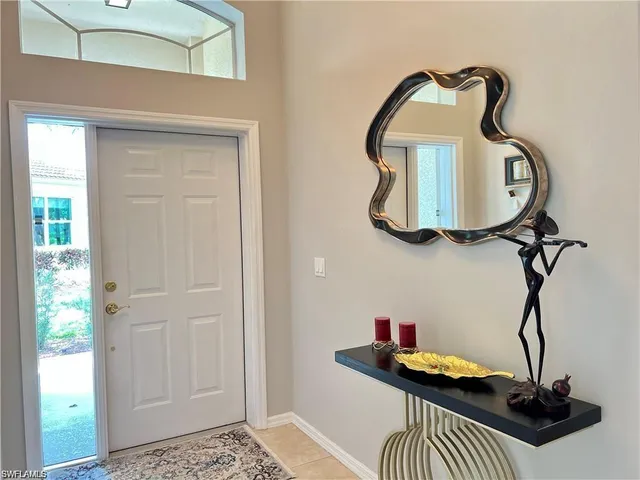 a table room with a wooden floor and potted plant
