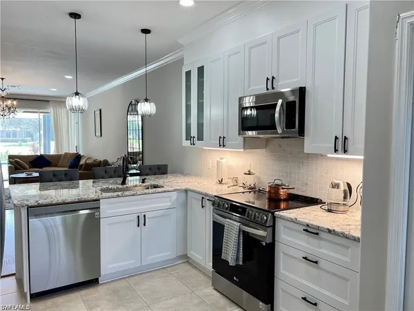 a kitchen with a sink stove and microwave