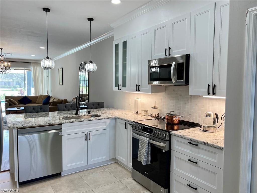 1812 Avian Court, Unit A78 Naples, FL 34119 - Photo 3 of 19 a kitchen with a sink stove and microwave