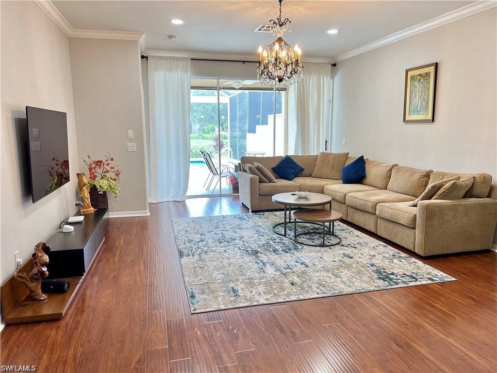 1812 Avian Court, Unit A78 Naples, FL 34119 - Photo 7 of 19 a living room with furniture and a flat screen tv